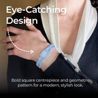 A close-up of a customer wearing the AV Edge Advanced Sky Blue frequency wristband paired with a smart black cardigan, highlighting the modern geometric design that might support improved focus, balance, and natural energy throughout a busy day.
