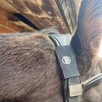 Close-up of a black AV Edge Horse Bridle Patch on a Fairfax leather headpiece. Uses EF Technology to potentially offer poll pressure relief, trigeminal nerve support, and aid equine focus.