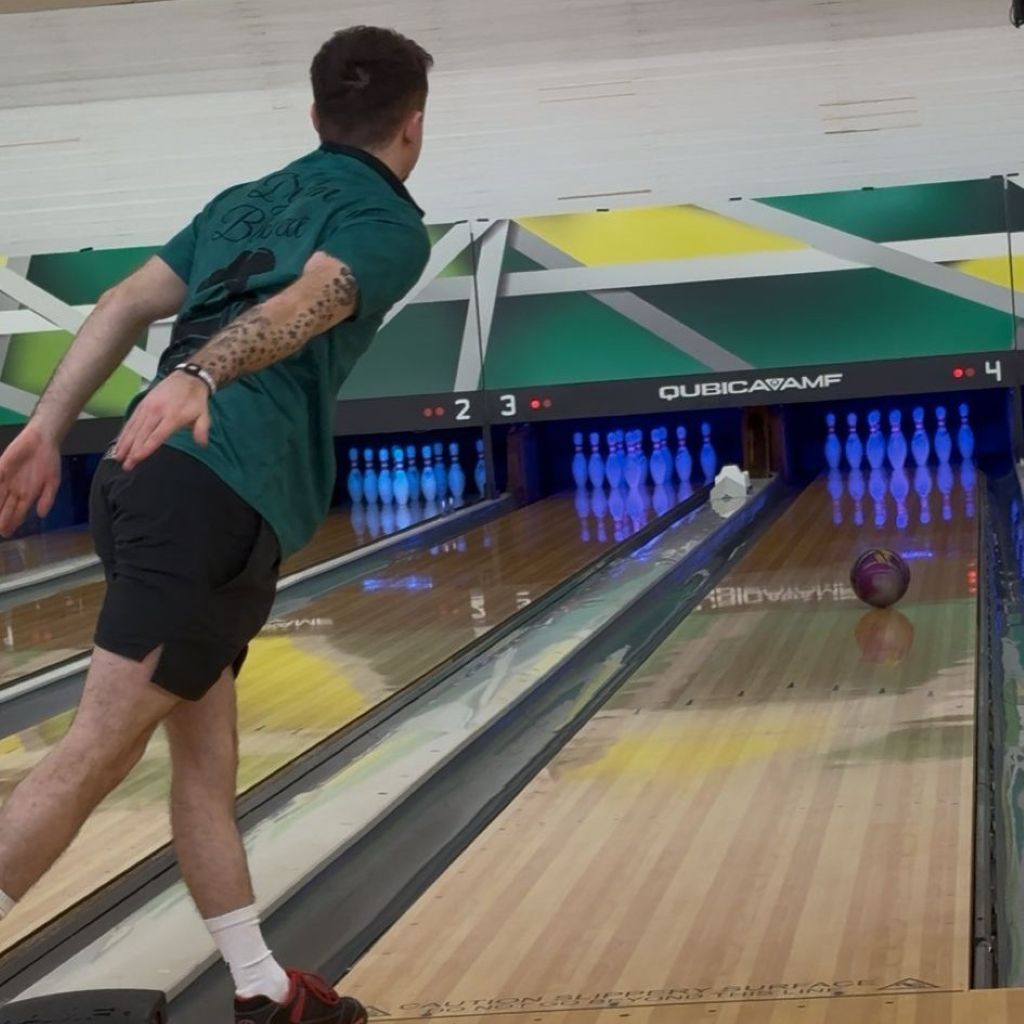 Dylan Blessett bowling at a bowling alley with a colourful lane design wearing his AV Edge Legend Wristband with with EF technology, frequencies, not magnets, that may protect against modern technology EMFs and improve health and performance by stimulating the production of adenosine triphosphate/ATP