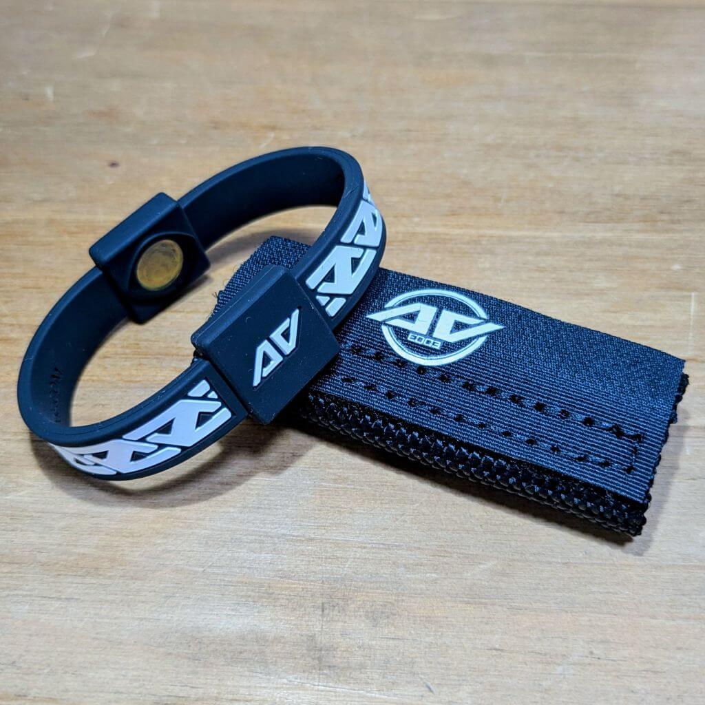 Dog and Owner Set showing a black Legend frequency technology wristband alongside a black canine collar patch with an embroidered AV Edge logo.
