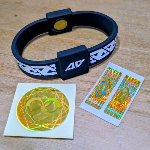 Everyday Protection Starter Set showing a black Legend frequency technology wristband alongside a gold circular laptop/tablet EMF protect filter and two gold rectangular mobile phone EMF protect filters on backing paper.