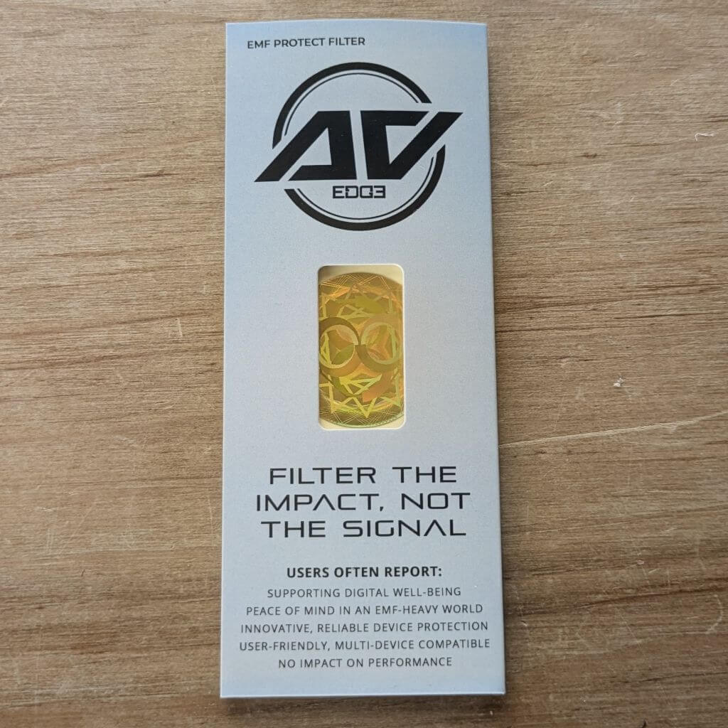 Packaging for the AV Edge Protect Filter for laptops and tablets, displaying a circular holographic frequency disc on branded card stock.