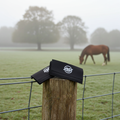 Horse bridle/collar patches in Black (with EF technology, frequencies, not magnets, that may protect against modern technology EMFs and improve health and performance by stimulating the production of adenosine triphosphate/ATP) on a wooden fence post